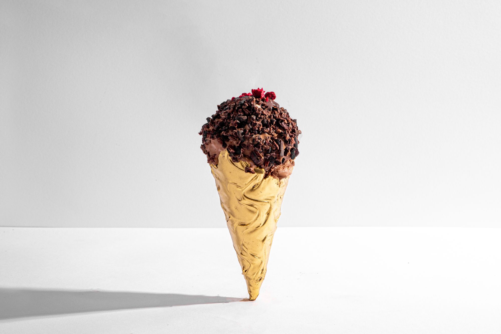 An ice cream cone that has been dusted with metallic gold powder.